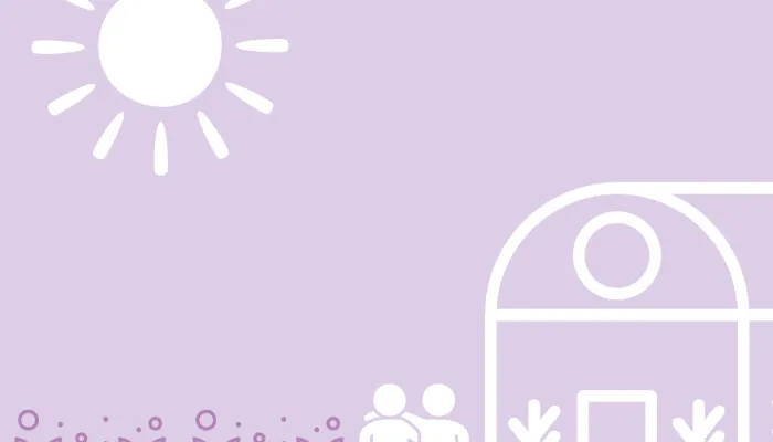 A pair of people stood beside a greenhouse and vegetable beds