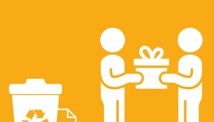 two people giving a gift next to a recycling bin