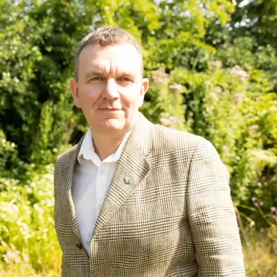 Evan Bowen-Jones, Chief Executive at KWT, with a woodland backdrop.