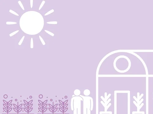 A pair of people stood beside a greenhouse and vegetable beds